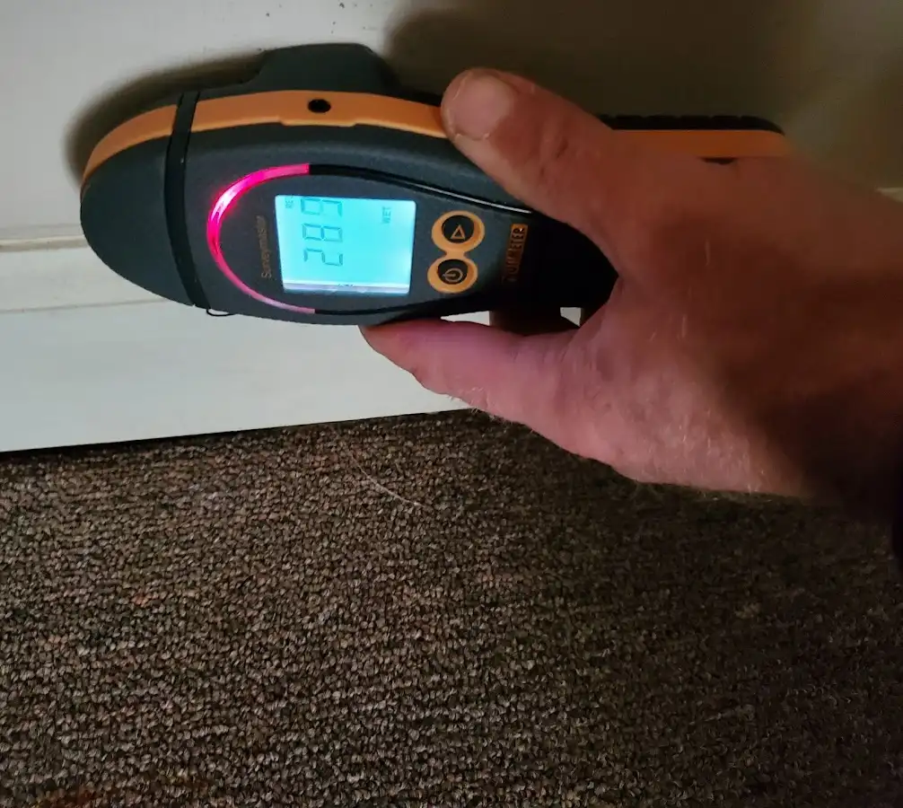 Moisture detection at baseboard during Storm Damage Restoration in North Valley